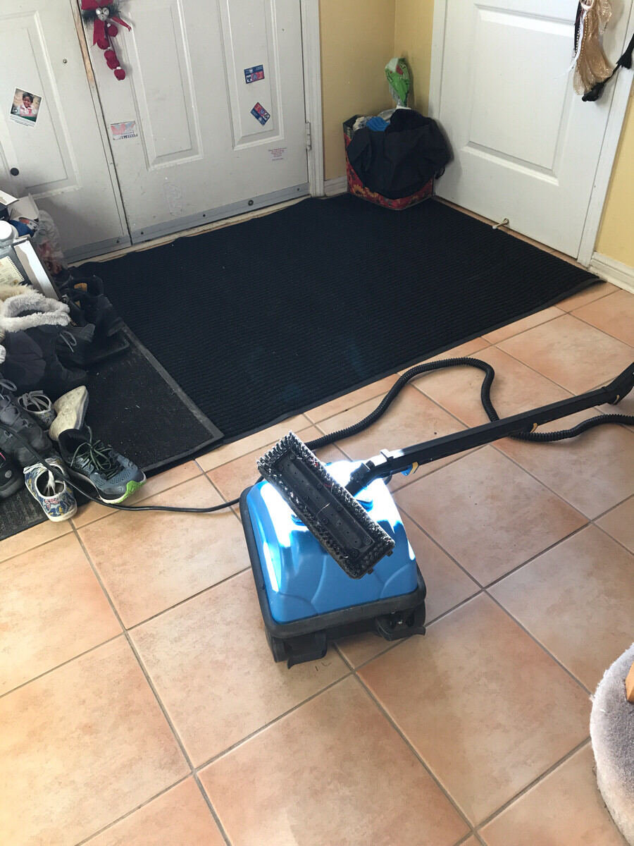 Commercial steam cleaner on tile and grout.